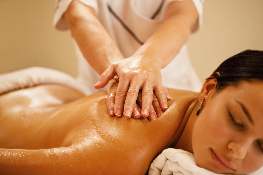 close up of woman getting back massage at the spa.